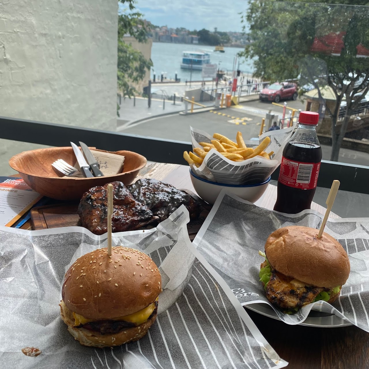 Burgers and chips at an outdoor table near The Rocks